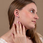 Heart & Cross Stud Earrings in 925 Sterling Silver – shown worn, close-up
