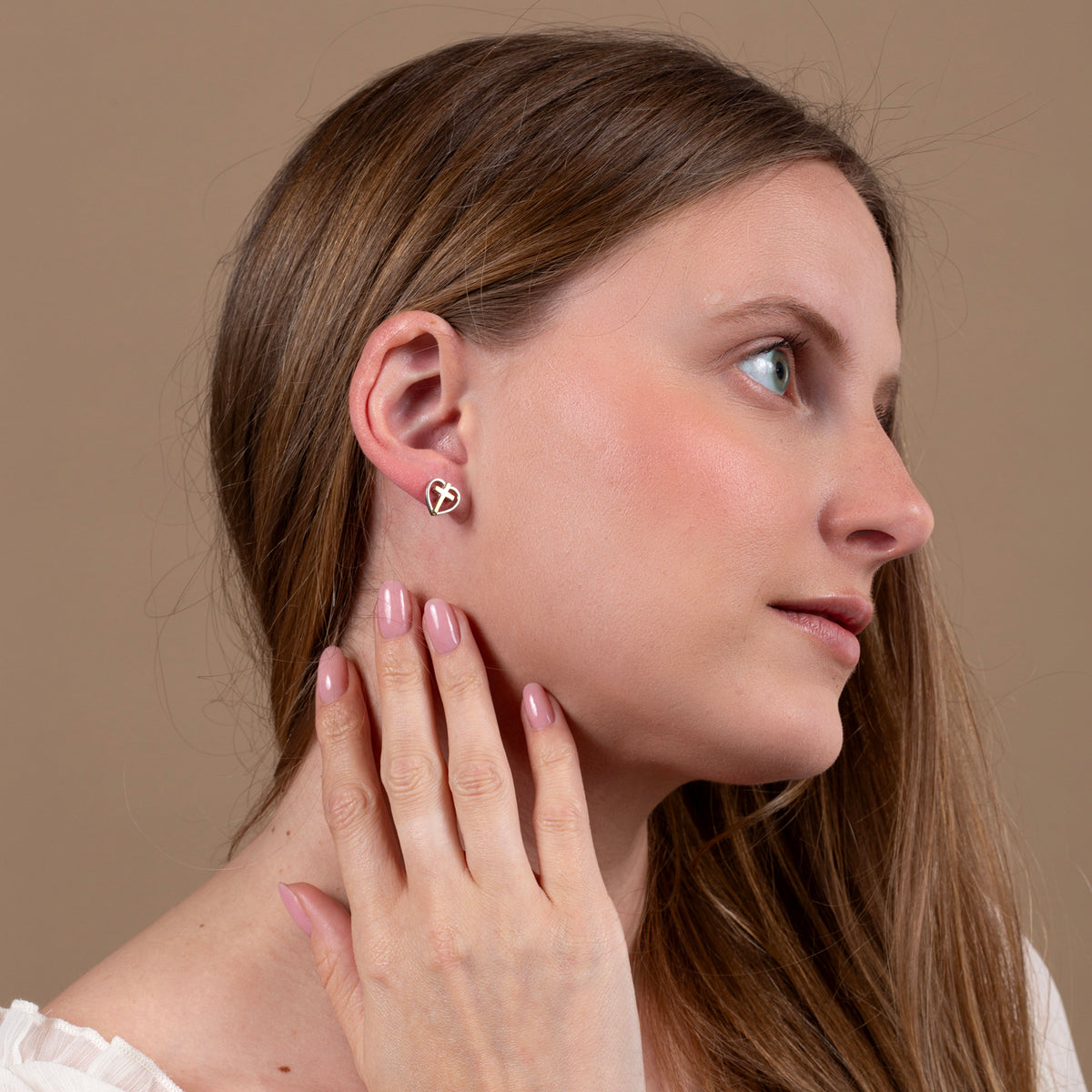Heart & Cross Stud Earrings, Bold Gold Cross, 925 Sterling Silver – shown worn, close-up