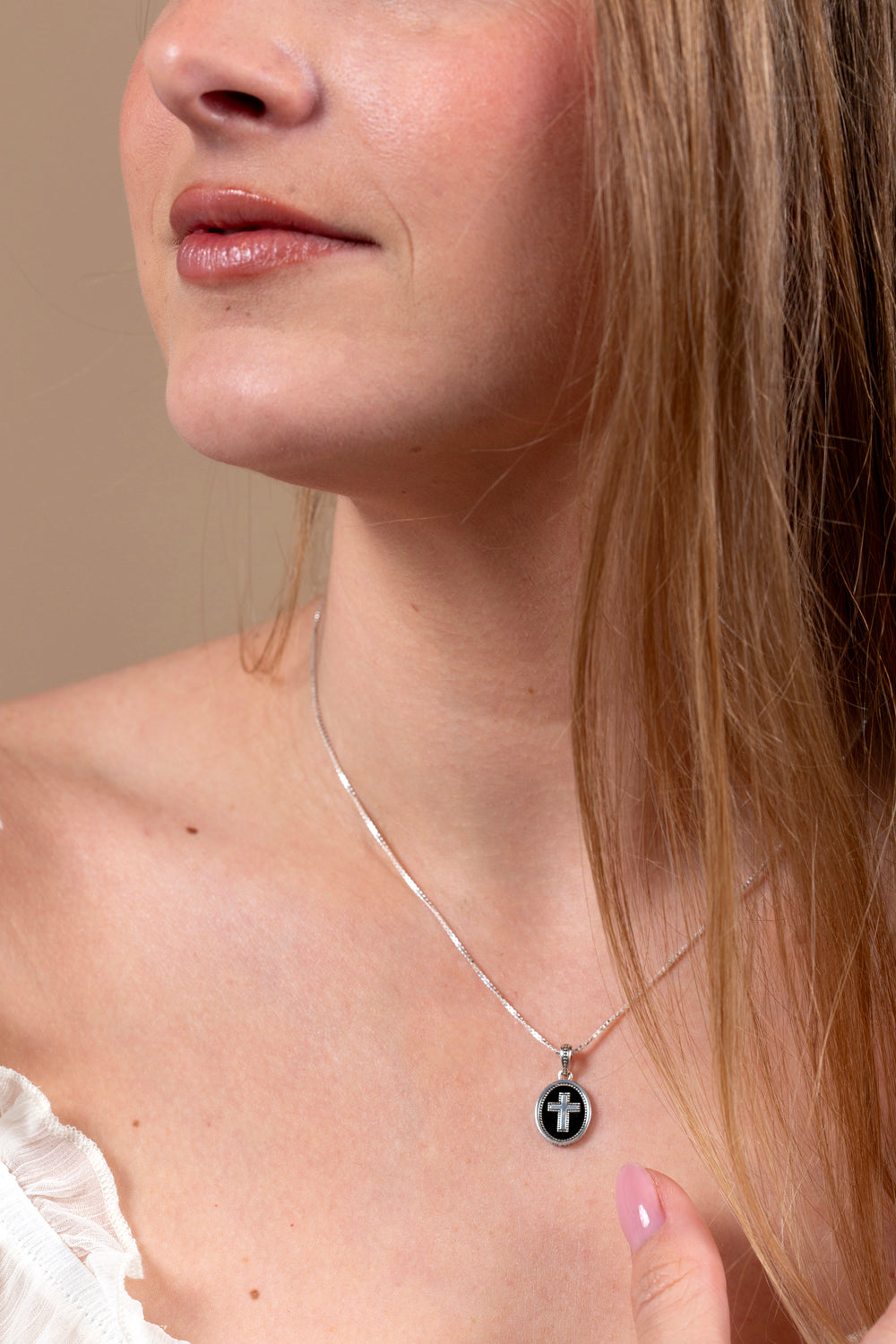 Onyx Cross Oval Pendant Necklace in 925 Sterling Silver – shown worn, close-up